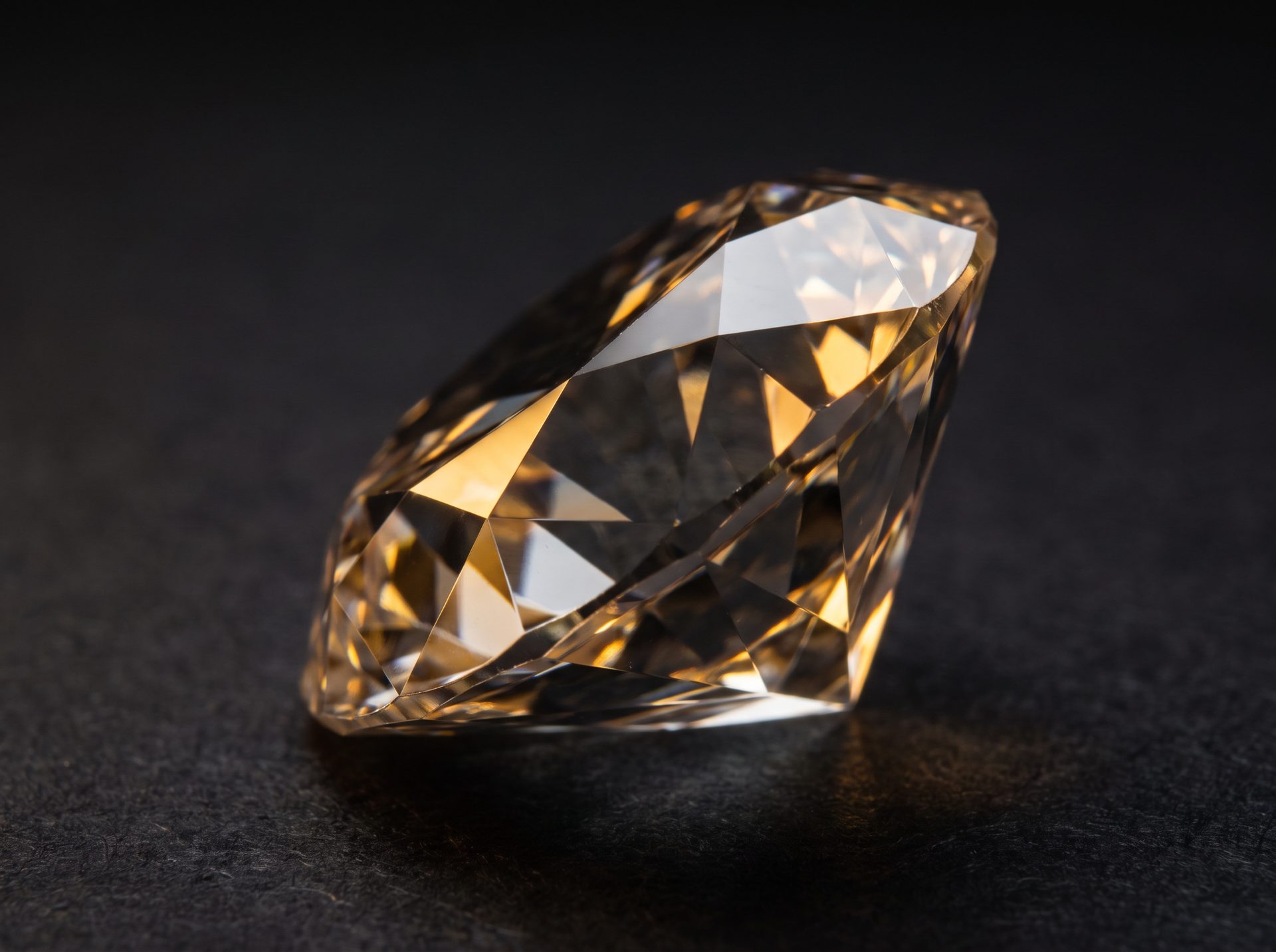 Close-up of a faceted diamond catching warm light, symbolizing precision and lasting value